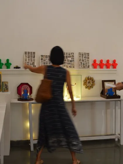 The guests from the French Consulate examining the shelf of curated memorabilia.