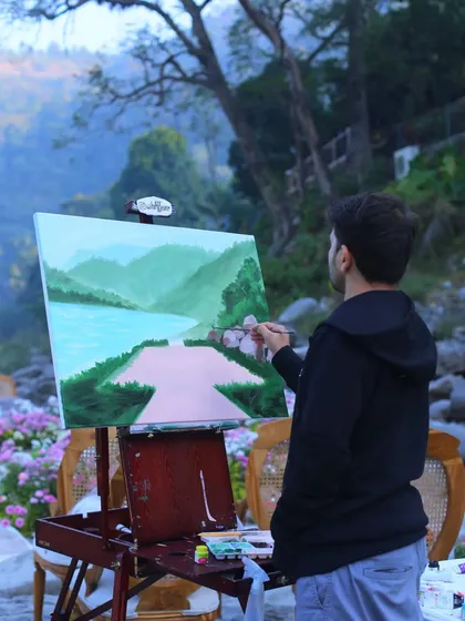 Adding details to the mountains and river in our Rishikesh painting. Getting the landscape just right is key for a destination piece.