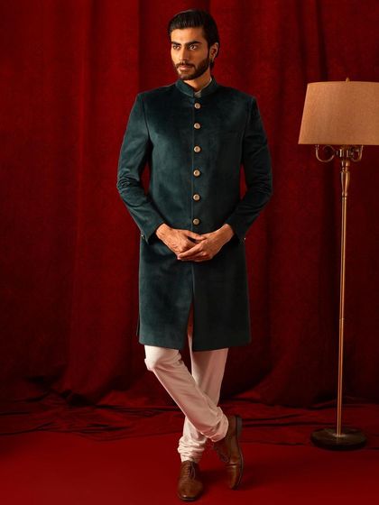 Another view of our timeless green velvet bandhgala. It’s a versatile piece that can be dressed up for a wedding or worn for a formal evening out.