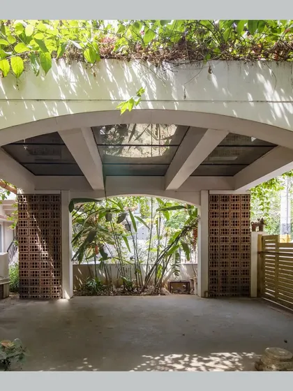 The car porch is covered by a 'flowering roof', a type of green roof, with a glass section to allow light through.