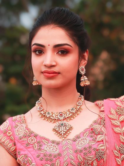 A soft glam look featuring a beautiful pink eyeshadow and a natural lip. This style is perfect for pre-wedding events where you want to look polished and radiant.