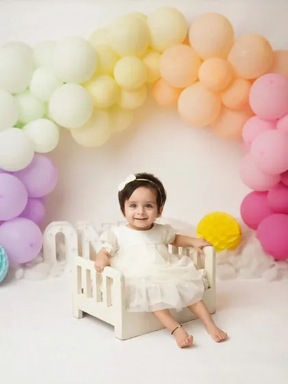 Turning one is a rainbow of emotions, and I love to celebrate it with color and joy. Milestone sessions like this are designed to capture your child's budding personality, from their sweet smiles to their curious glances. This is a perfect way to mark their first big birthday.