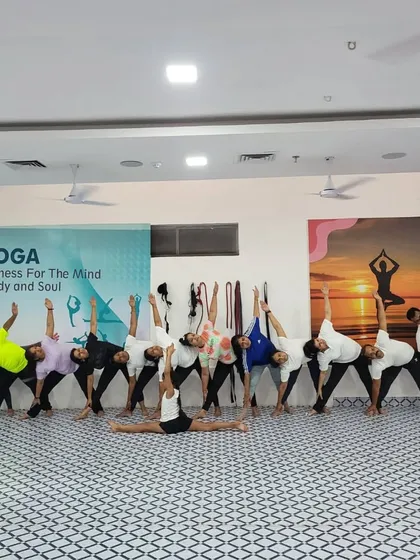 A wide shot of our group practicing Trikonasana (Triangle Pose) together. The alignment and synchronicity are beautiful to see.