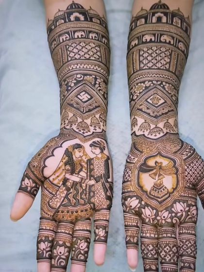 A classic design showing the varmala ceremony. The bride and groom portraits are the centerpiece, surrounded by auspicious symbols like the swastika and kalash.