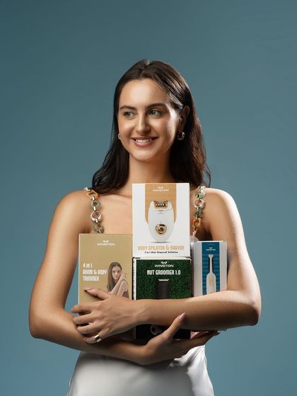 A shot of the model holding the full range of grooming products. This is an excellent way to showcase a brand's entire collection in one image.