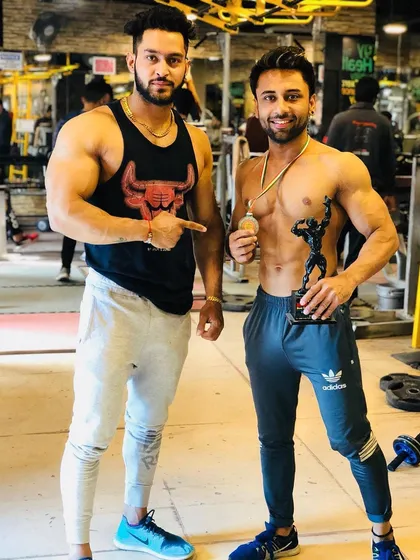Another champion made. Standing with my client as he holds his trophy and medal. My role as a coach is to guide you to unlock your own potential and achieve these winning moments.