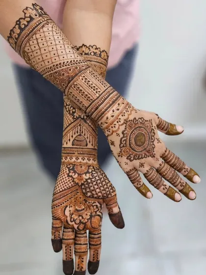 This engagement mehendi combines a central mandala on one hand with fuller, more traditional patterns on the other. It's a great way to have two distinct yet complementary styles.