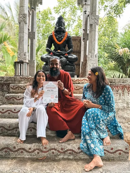 Three students celebrate a graduation, receiving their certificates at our outdoor shrine. This is a moment of pride, joy, and spiritual accomplishment.