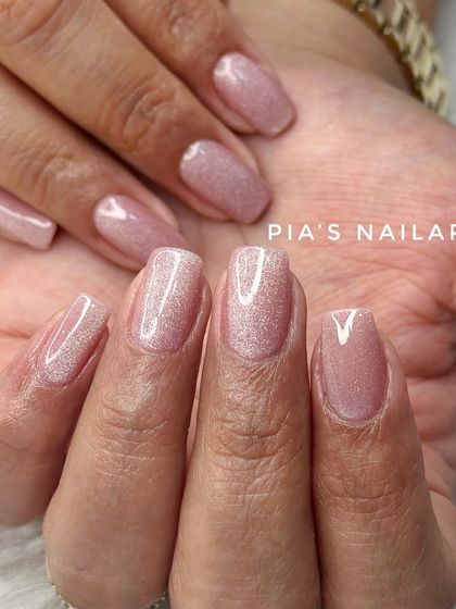 Soft cat eye nails are a great option for a subtle, shimmery look. This light pink magnetic polish is perfect for everyday wear.