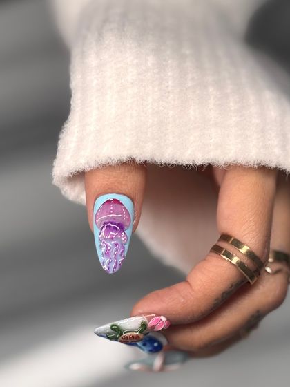 A focus on the hand-painted jellyfish nail from the 3D ocean set. The delicate details and vibrant colors bring this tiny work of art to life.