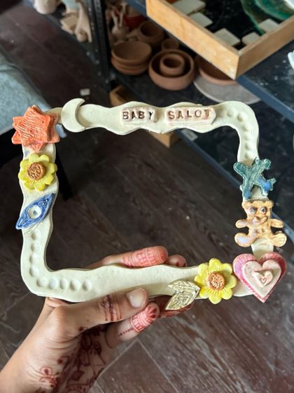 A custom "Baby Saloni" photo frame, full of adorable, handmade details. A keepsake that will last forever.