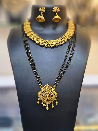 A combo of a traditional choker and a long mangalsutra-style necklace with a temple pendant.