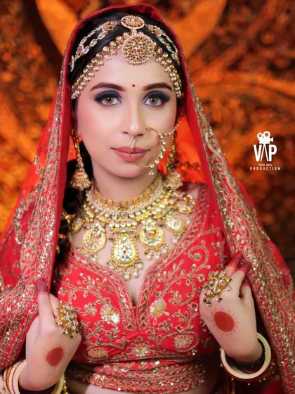 This is the classic, royal bridal look that never goes out of style. This bride is adorned in a complete traditional kundan jewellery set, including a heavy layered necklace, matha patti, nath, and matching rings, all available for purchase at my store.