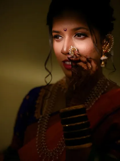 A classic bridal portrait using creative shadow and light to accentuate the bride's features and her traditional Maharashtrian 'nath'.