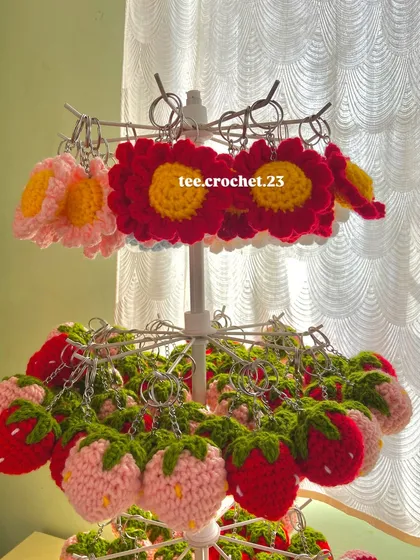My flower and strawberry keychains are some of my bestsellers. This image highlights the detailed stitching and bright colors that make them stand out.
