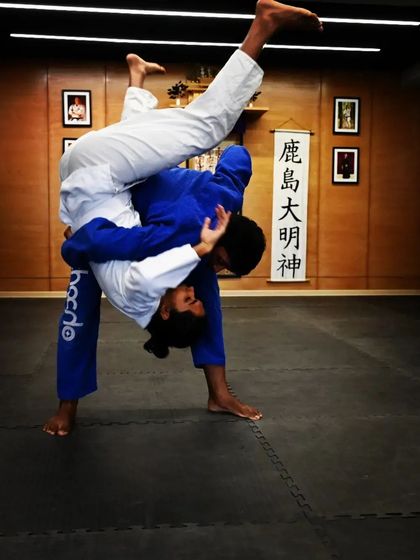 A dynamic shot of a takedown being practiced during a Gi class at The Dojo. Training takedowns is a key part of our curriculum for a complete Jiu-Jitsu game.