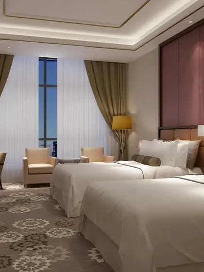 Our design work extends to creating premium hospitality experiences. This twin guest room combines comfort with high-end style, featuring a full-height padded headboard wall, sophisticated lighting, and a rich color palette to ensure a restful and luxurious stay for any guest.