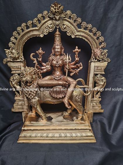 A frontal view of the Durga sculpture, highlighting the fierce expression of the lion and the calm, determined face of the goddess.