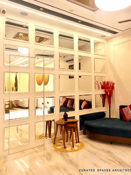 A closer look at the grid-style mirror wall I designed. This feature not only adds a decorative element but also makes the entire living area feel larger and brighter by reflecting light and space.