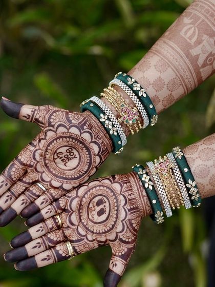 A detailed look at a baby shower mehendi featuring a baby face on one palm and the "Boy or Girl?" question on the other. The dark fingertips are a classic touch that makes the design pop.