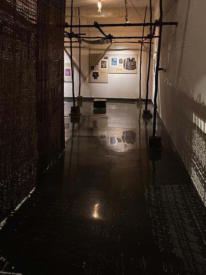 A view down a corridor created by the installation, with shadows patterning the walls.