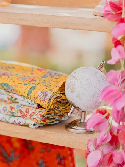 A small detail from our 'Rajasthani Folklore' Mehendi. We used a miniature globe and stacks of colorful, block-printed fabrics to create charming little vignettes.