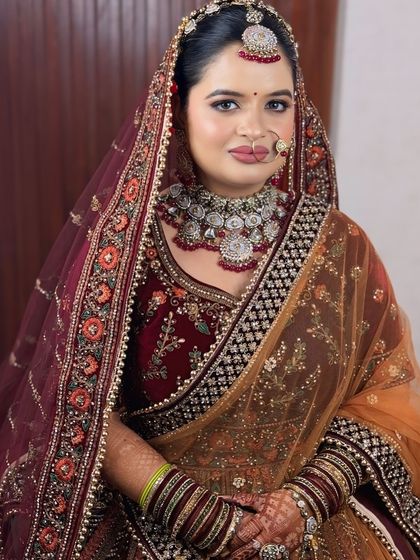 This bride opted for a unique look with a maroon velvet lehenga and a contrasting mustard dupatta. The makeup was designed to tie the colors together.