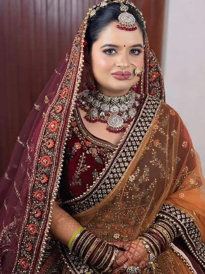 This bride opted for a unique look with a maroon velvet lehenga and a contrasting mustard dupatta. The makeup was designed to tie the colors together.