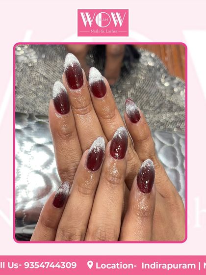 A bold and beautiful design featuring a deep red base with a sparkling silver glitter ombré at the tips. This look on long, almond-shaped nails is pure glamour.