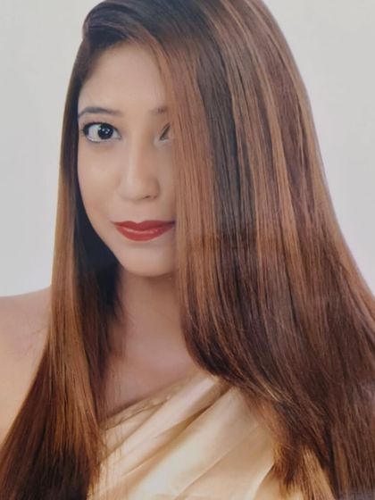 A sleek, straight hairstyle showcasing a beautiful, warm brown global color.