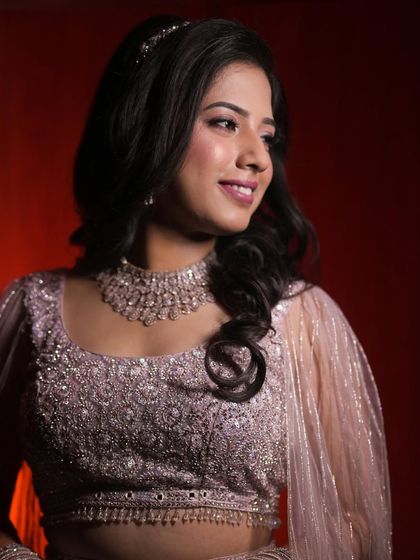 Shruti smiling during her reception. The soft glam makeup ensures she looks radiant and happy in every photograph.