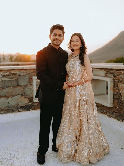 A classic couple portrait on a terrace overlooking the Aravalli hills in Udaipur.