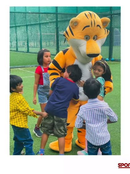 Kids gathering around for a hug with the tiger mascot. It's all about creating a warm, friendly, and exciting atmosphere at my sports-themed parties.