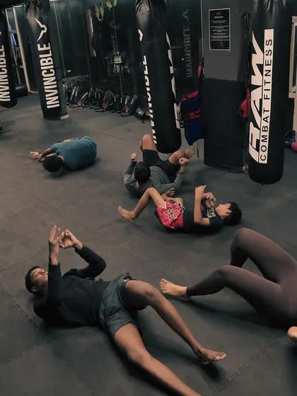 The class cools down with core exercises after a tough session. The work isn't over until the last rep.