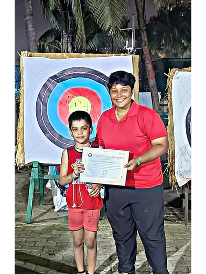 One of our coaches congratulating a young participant on completing the May 2023 summer camp.
