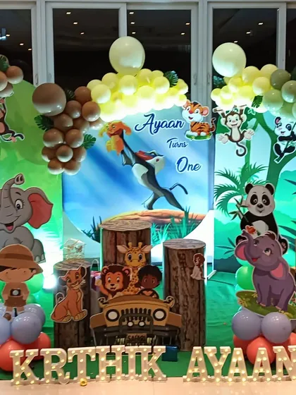 A close-up view of the Lion King themed decoration, highlighting the detailed character cutouts and wood-textured pedestals.