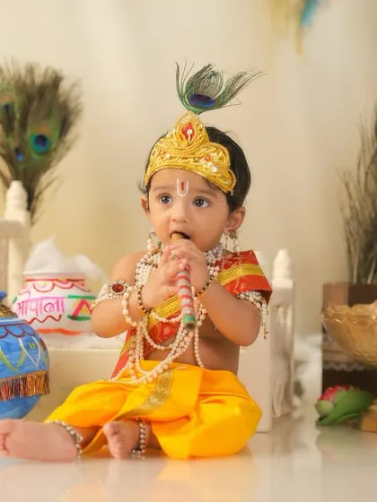 A close-up of our little Krishna curiously tasting his pearl necklace, a candid moment from the Janmashtami themed shoot.