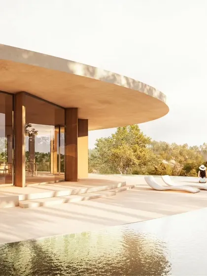 The elegant curve of the roof provides shade for the outdoor terrace, creating a comfortable space to enjoy the views.