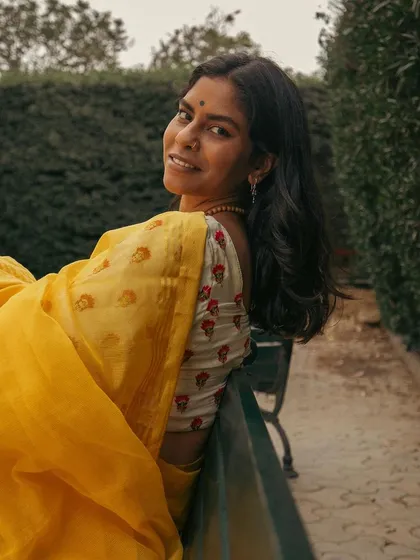 A joyful and candid shot on a park bench, capturing a natural smile. This style of portraiture is perfect for creating relatable and warm images for your personal collection.