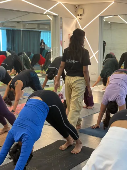 The energy of a full class moving together is incredible. Here, our community flows through Adho Mukha Svanasana (Downward-Facing Dog) during our International Yoga Day event.