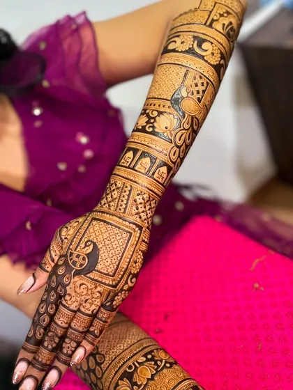 A full-arm design created in collaboration, showcasing intricate grid work and peacock motifs.