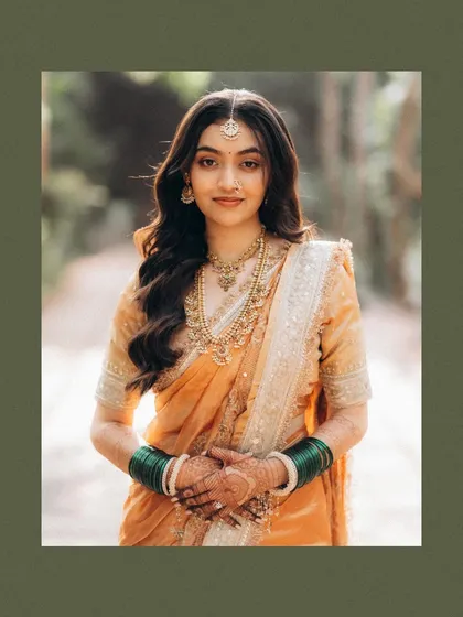 A beautiful, serene portrait of the bride. The soft focus and natural background create a gentle, timeless look that lets her natural beauty shine.