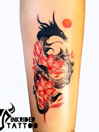 We love bringing vibrant ideas to life with color. This dragon tattoo, wrapped in red blossoms, shows our skill in creating dynamic and colorful designs that flow with the body. It’s a symbol of power and grace, executed with rich saturation and sharp lines.