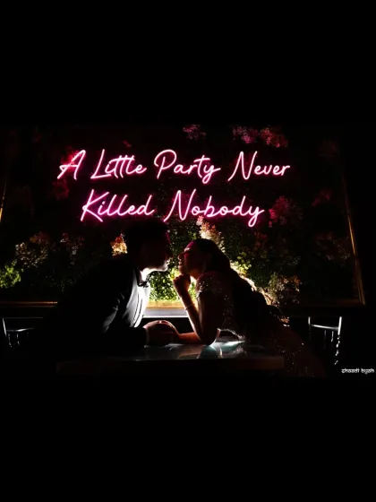"A Little Party Never Killed Nobody." This silhouette from a cocktail night captures the cool, modern vibe of the celebration. It’s a stylish shot that shows the fun side of the wedding festivities.