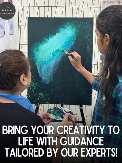 An instructor helps a student with her abstract canvas painting, demonstrating blending techniques to bring her vision to life.