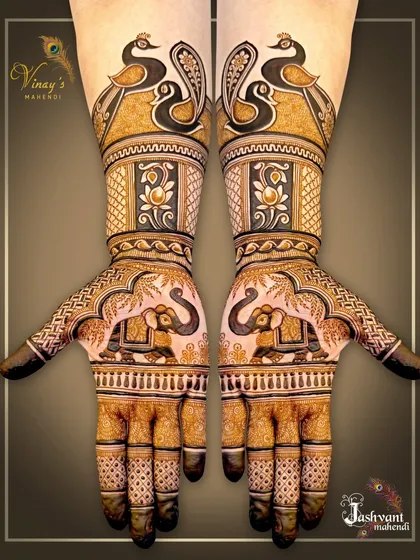 A bold and beautiful symmetrical design featuring pairs of elephants on the palms and elegant peacocks on the forearms. The use of negative space makes the motifs pop.