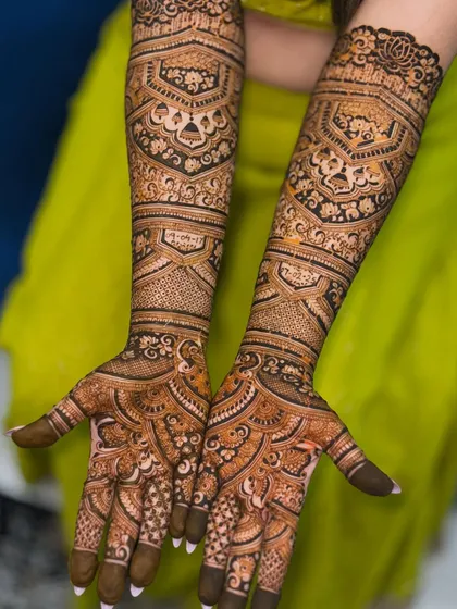 A full and intricate bridal design that extends up the arms. The patterns are dense and detailed, perfect for a bride who wants a truly traditional and statement-making mehendi.