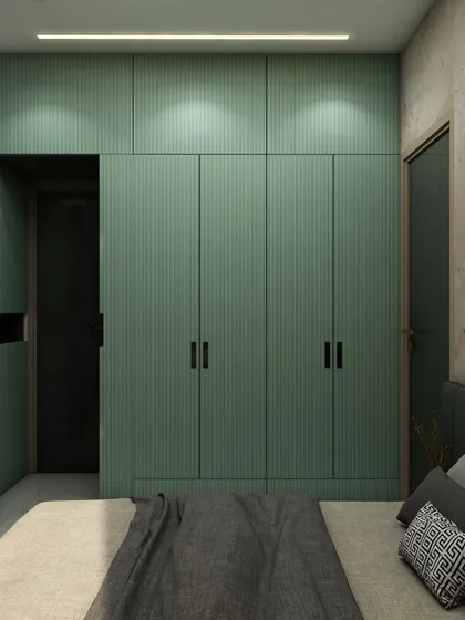 A closer look at the mint green fluted wardrobes, which add a subtle texture and a pop of color to the serene bedroom design.