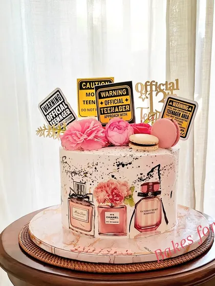 The same perfume-themed cake, but with fun "Warning: Official Teenager" signs added for a playful touch.