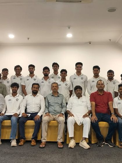 The team poses with club officials for a formal photograph after securing promotion to the 'A' Division, a significant achievement for the club.